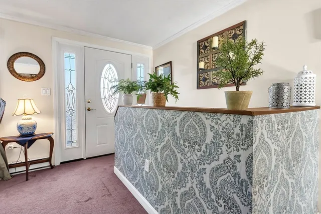 a view of a living room filled with furniture and a potted plant