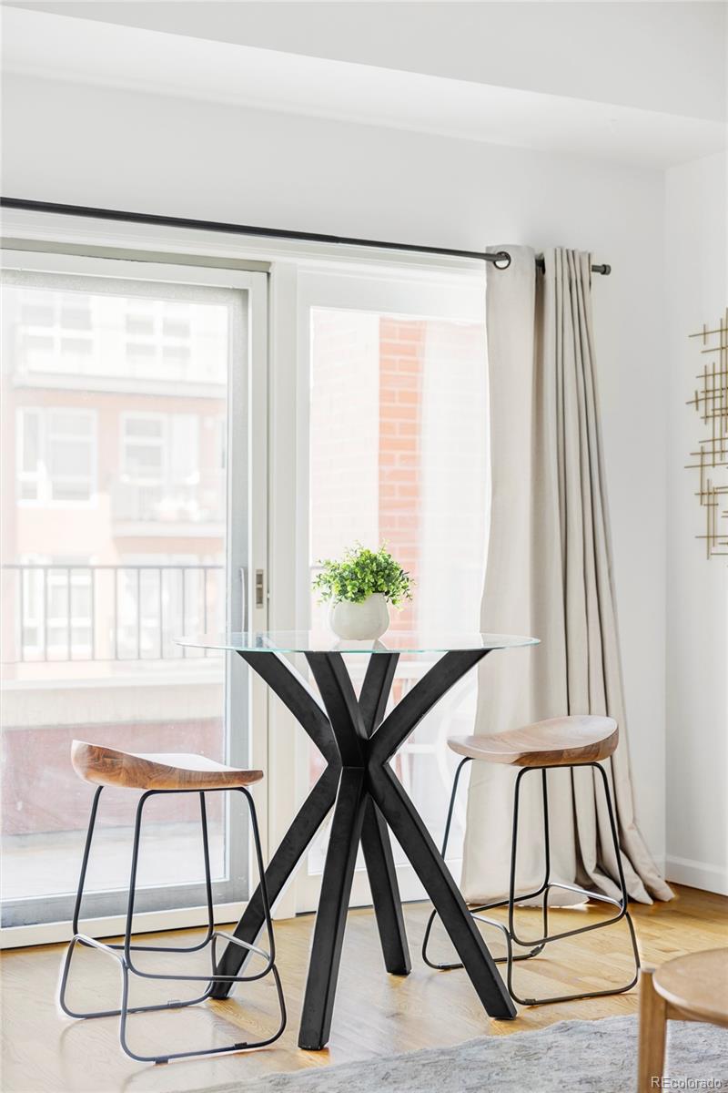 1950 Logan Street, Unit 1013 Denver, CO 80203 - Photo 11 of 23 a view of a dining room with furniture and a window