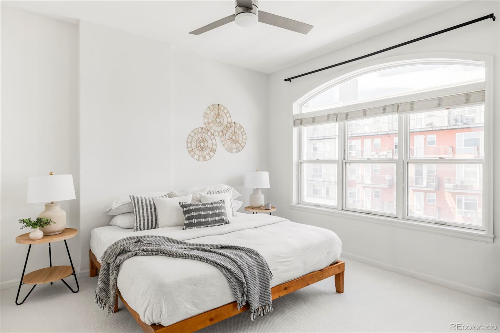 1950 Logan Street, Unit 1013 Denver, CO 80203 - Photo 13 of 23 a bedroom with a bed and a large window