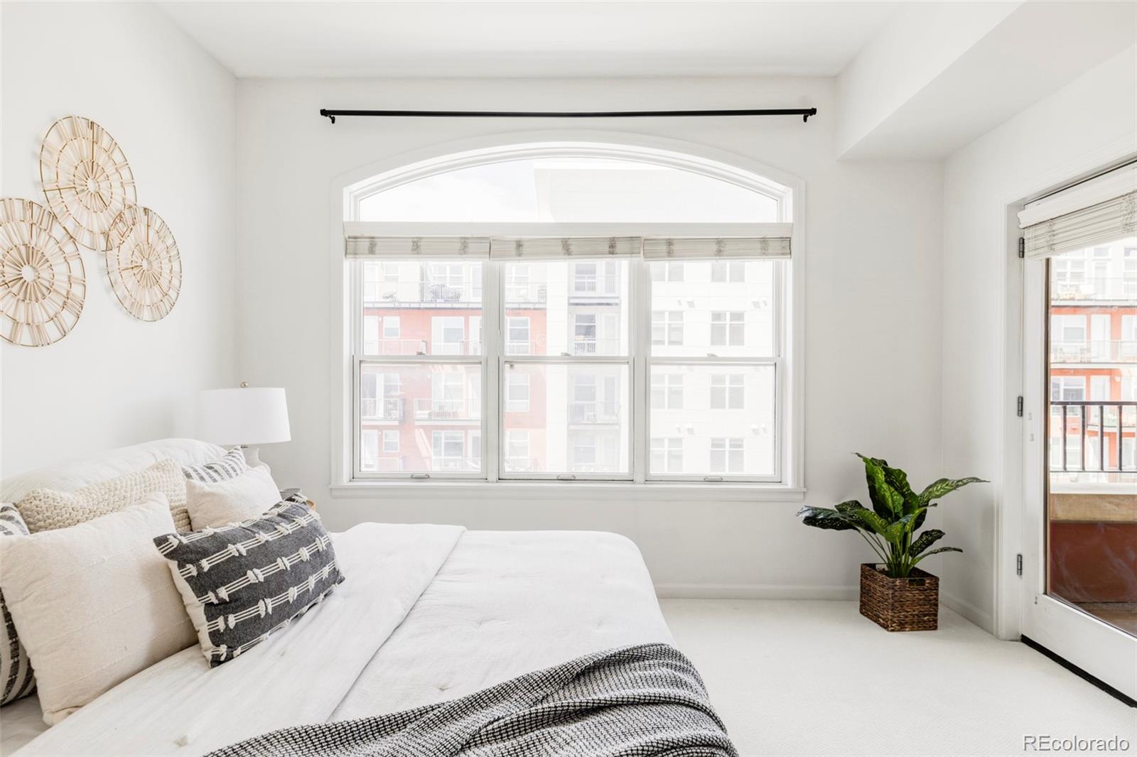 1950 Logan Street, Unit 1013 Denver, CO 80203 - Photo 14 of 23 a bedroom with a bed and window with couch