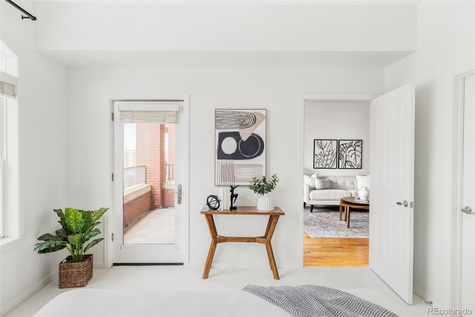 1950 Logan Street, Unit 1013 Denver, CO 80203 - Photo 15 of 23 a living room with furniture and a potted plant