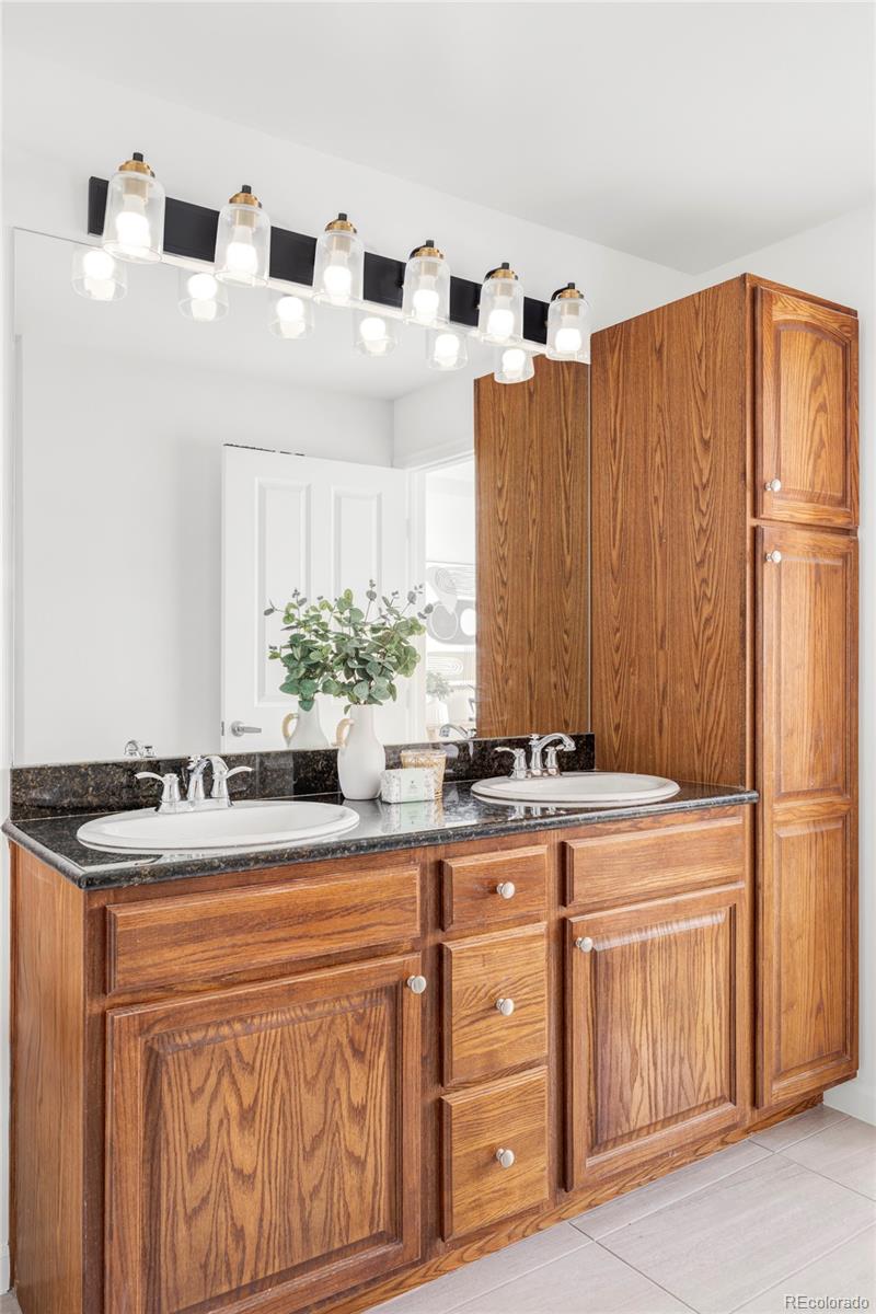 1950 Logan Street, Unit 1013 Denver, CO 80203 - Photo 19 of 23 a kitchen with stainless steel appliances granite countertop a sink and a refrigerator