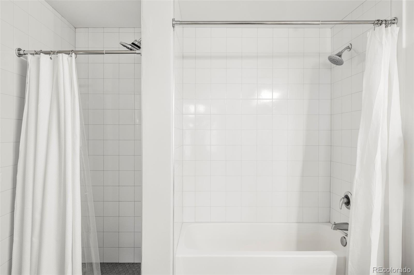 1950 Logan Street, Unit 1013 Denver, CO 80203 - Photo 20 of 23 a bathroom with a shower and a tub