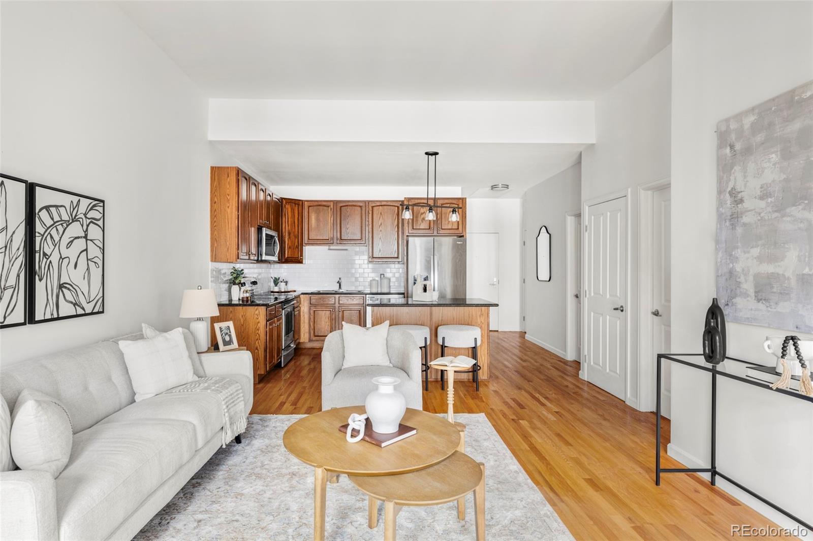 1950 Logan Street, Unit 1013 Denver, CO 80203 - Photo 2 of 23 a living room with furniture and kitchen view