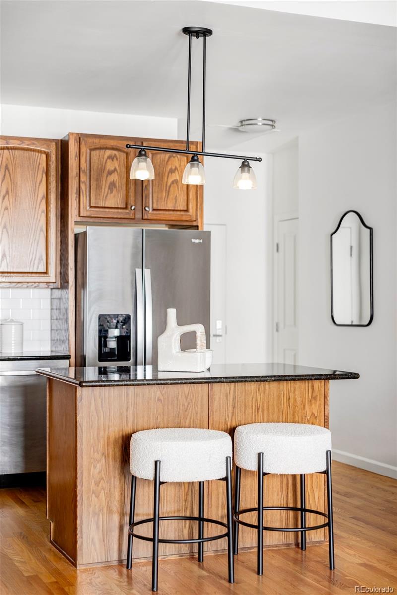 1950 Logan Street, Unit 1013 Denver, CO 80203 - Photo 4 of 23 a kitchen with a table and chairs in it