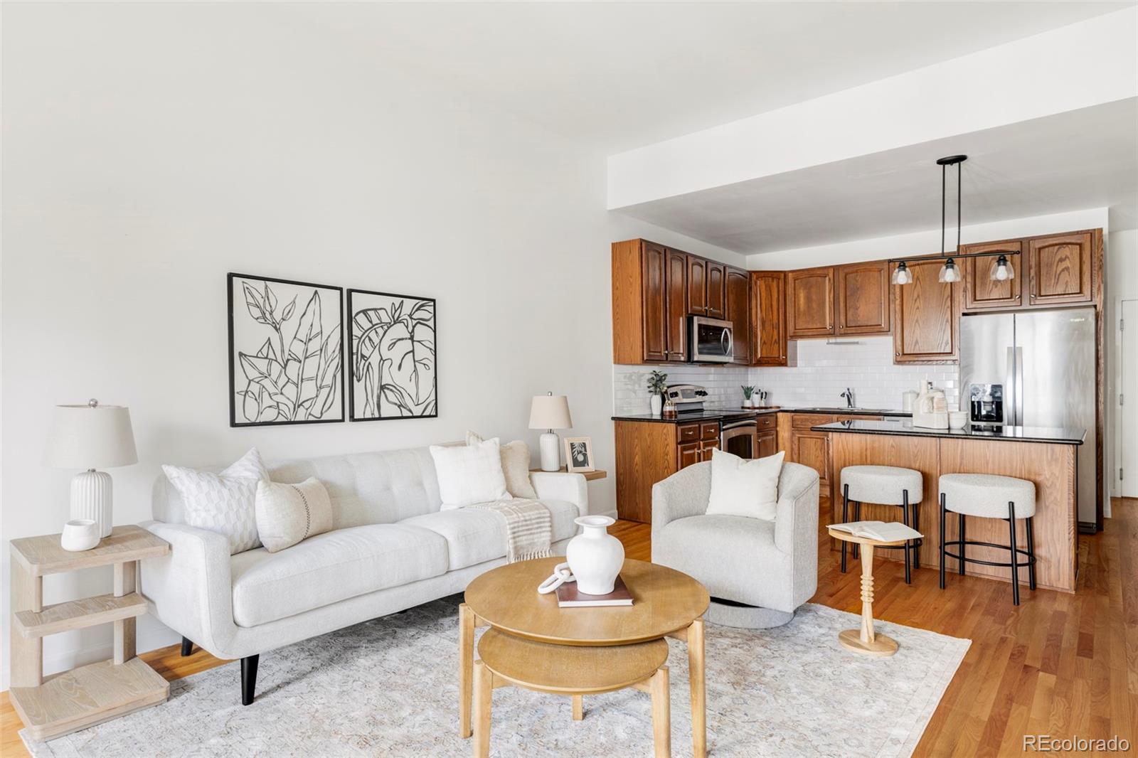 1950 Logan Street, Unit 1013 Denver, CO 80203 - Photo 7 of 23 a living room with stainless steel appliances kitchen island granite countertop furniture and a view of kitchen