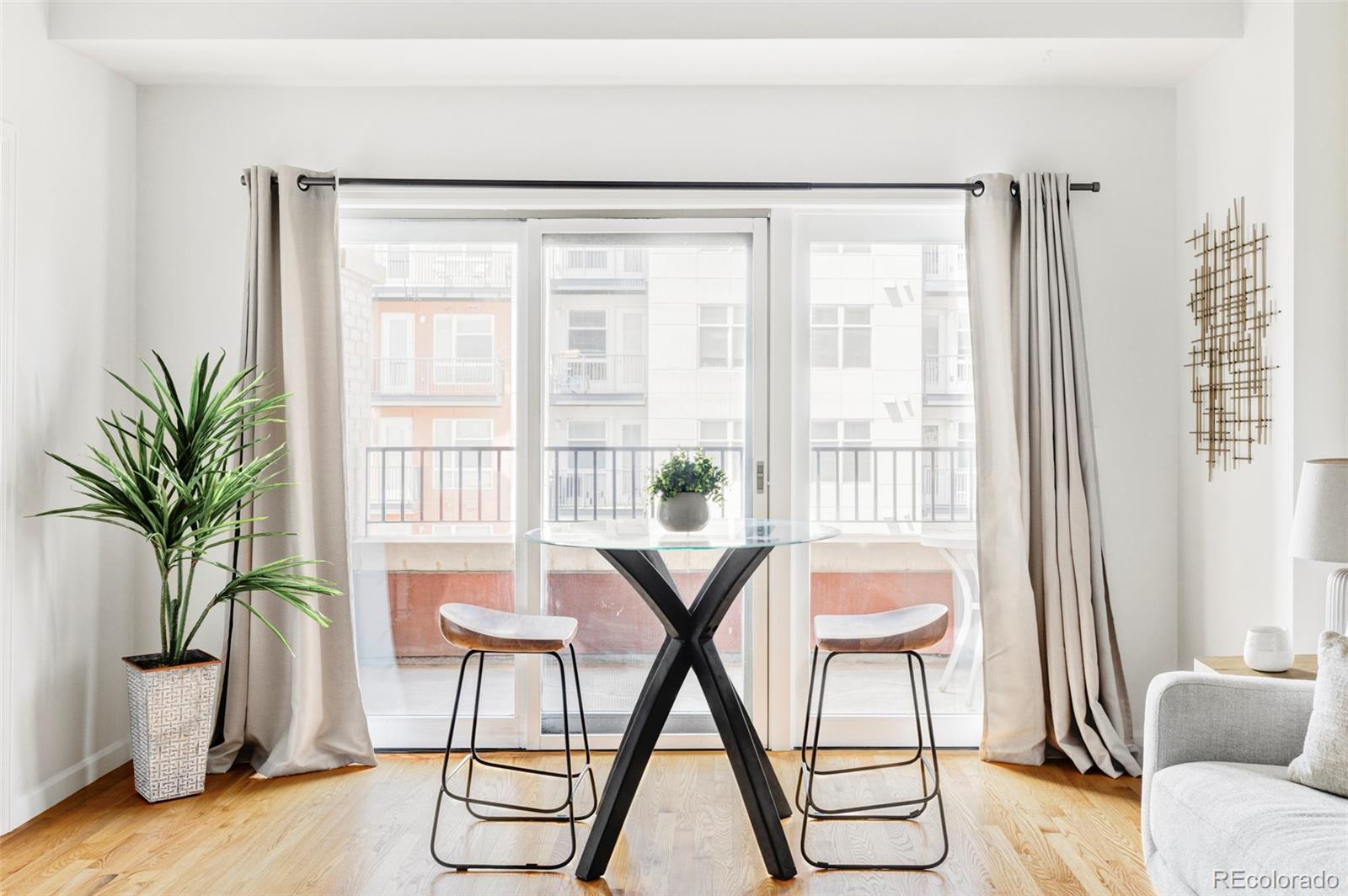 1950 Logan Street, Unit 1013 Denver, CO 80203 - Photo 10 of 23 a living room with furniture and a potted plant