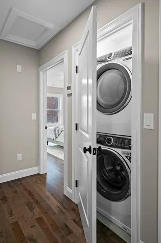 a bedroom with a large bed chandelier and a window