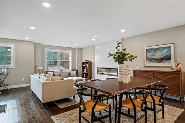 a living room with furniture a table and a potted plant
