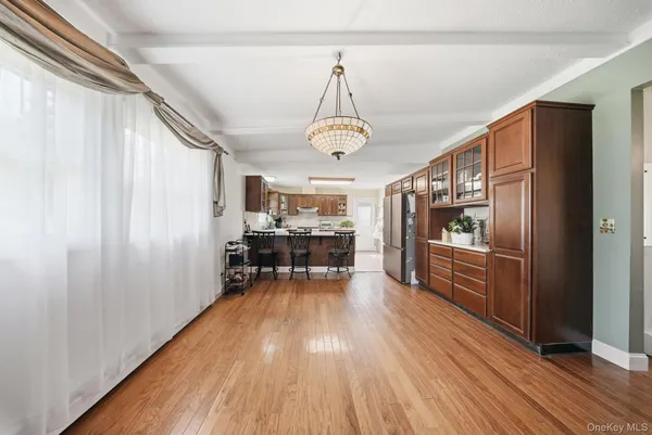 a very nice looking room with wooden floor and furniture