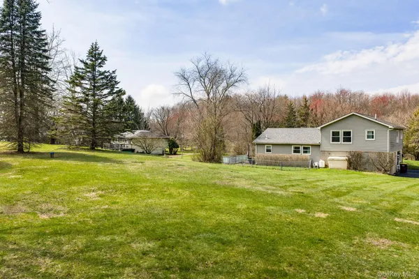 a house view with swimming pool in front of it