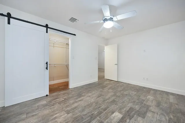 a view of an empty room with a ceiling fan