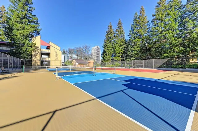 a view of swimming pool with lawn chairs and plants