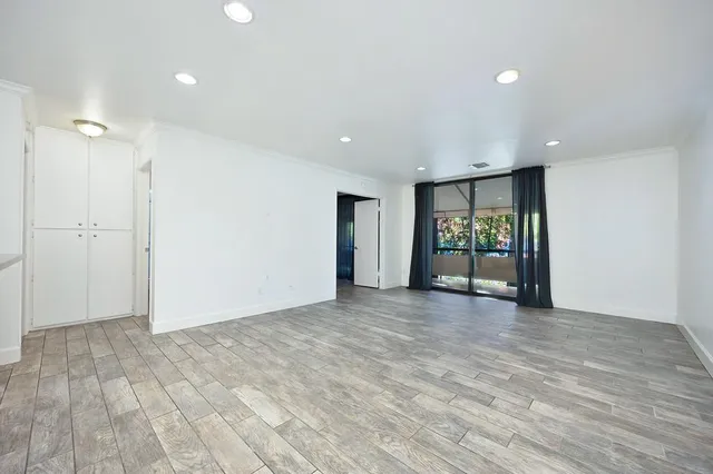 a view of an empty room with glass door