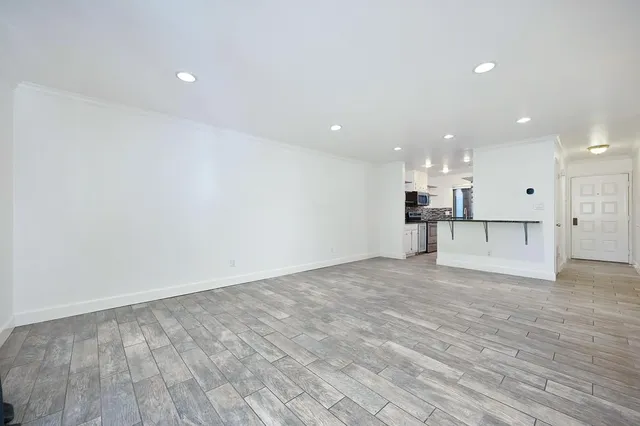a view of kitchen with a refrigerator and a sink