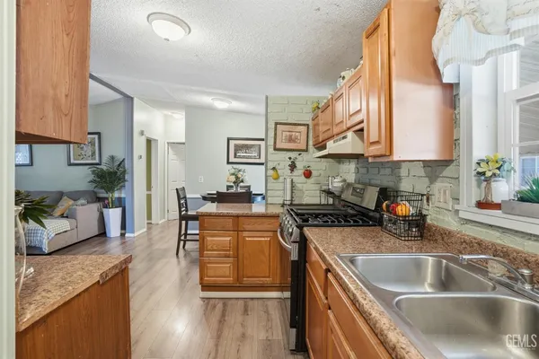 a living room with furniture a flat screen tv and a wall painting