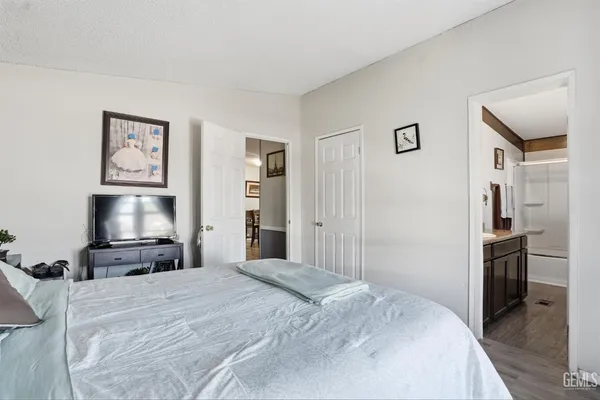 an aerial view of a city with lots of residential buildings and mountain view in back