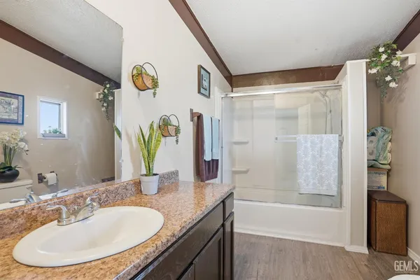 an aerial view of residential houses with outdoor space and ocean view