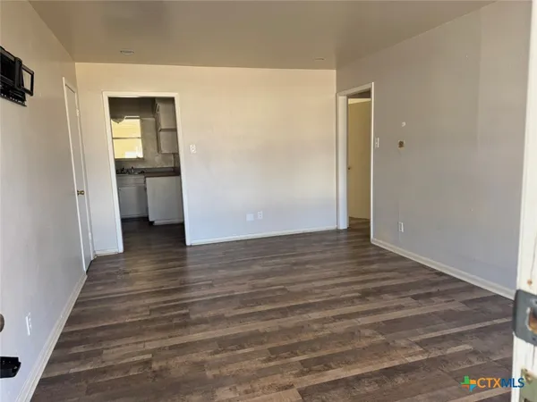 a view of a hallway view with wooden floor and staircase