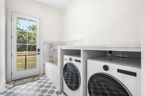 a bathroom with a double vanity sink mirror and shower
