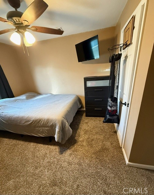 4552 West Ave L12 Lancaster, CA 93536 - Photo 11 of 39 a bedroom with a bed and a flat screen tv