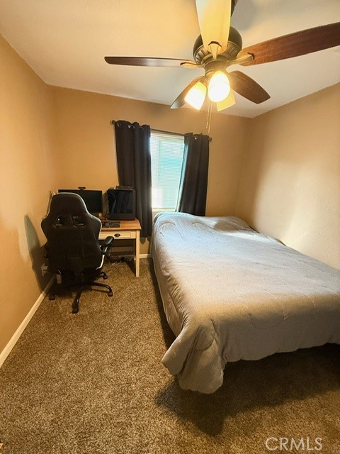 4552 West Ave L12 Lancaster, CA 93536 - Photo 12 of 39 a bedroom with a bed and a chandelier