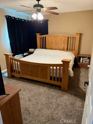 a bedroom with a bed and ceiling fan