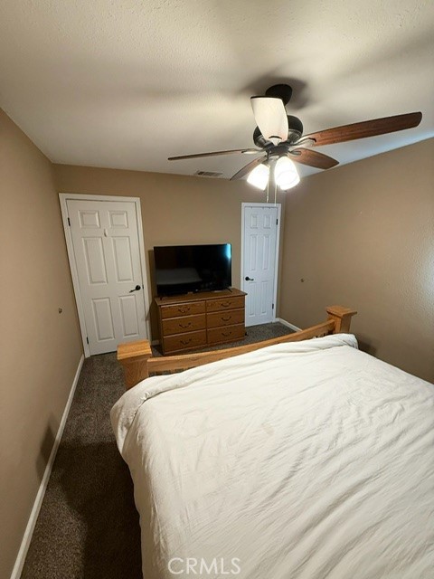 4552 West Ave L12 Lancaster, CA 93536 - Photo 15 of 39 a bedroom with a bed and a chandelier