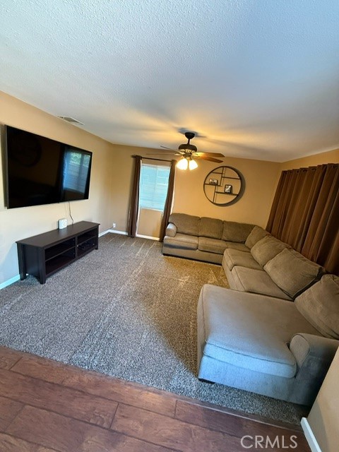 4552 West Ave L12 Lancaster, CA 93536 - Photo 17 of 39 a living room with furniture and a flat screen tv