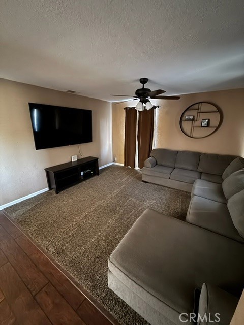 4552 West Ave L12 Lancaster, CA 93536 - Photo 21 of 39 a living room with furniture and a flat screen tv