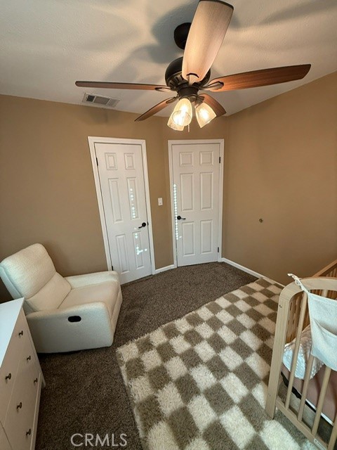 4552 West Ave L12 Lancaster, CA 93536 - Photo 24 of 39 a bedroom with a bed and a chandelier