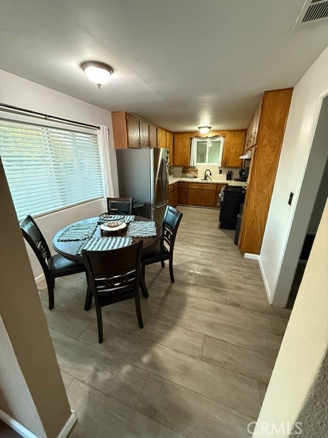 4552 West Ave L12 Lancaster, CA 93536 - Photo 27 of 39 a view of a dining room with furniture window and wooden floor