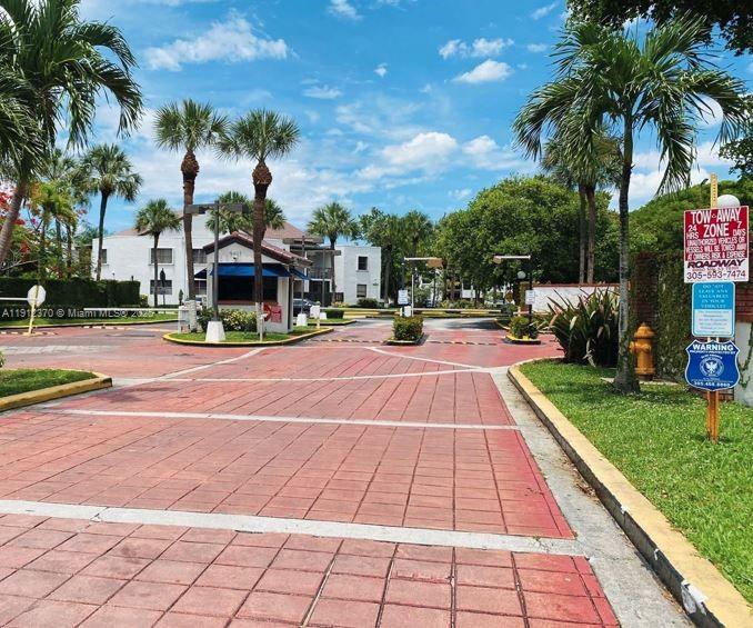 a front view of a building with palm trees