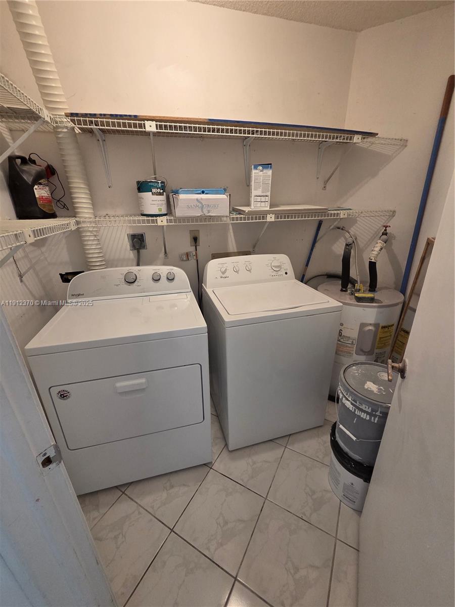 9433 Fontainebleau Boulevard, Unit 212 Miami, FL 33172 - Photo 11 of 45 a utility room with dryer and washer