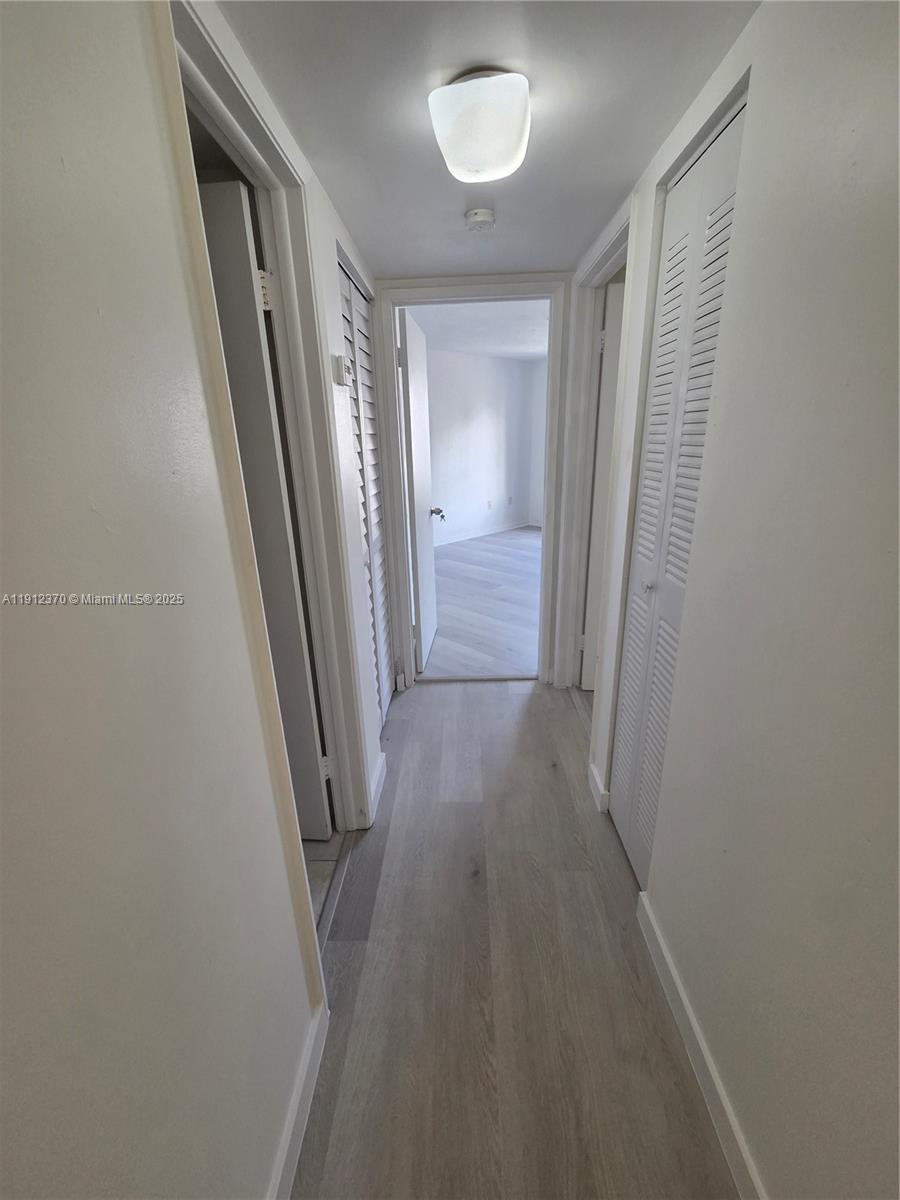 9433 Fontainebleau Boulevard, Unit 212 Miami, FL 33172 - Photo 14 of 45 a view of a hallway