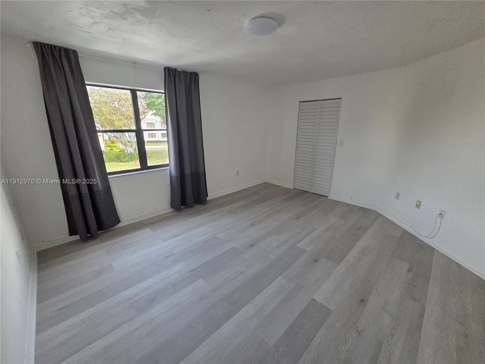 9433 Fontainebleau Boulevard, Unit 212 Miami, FL 33172 - Photo 17 of 45 an empty room with windows