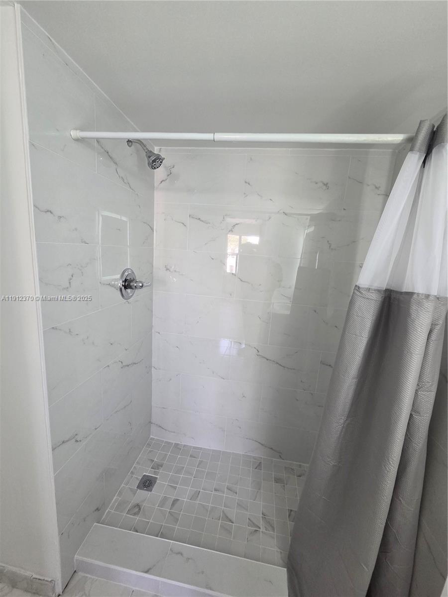 9433 Fontainebleau Boulevard, Unit 212 Miami, FL 33172 - Photo 19 of 45 a bathroom with a shower