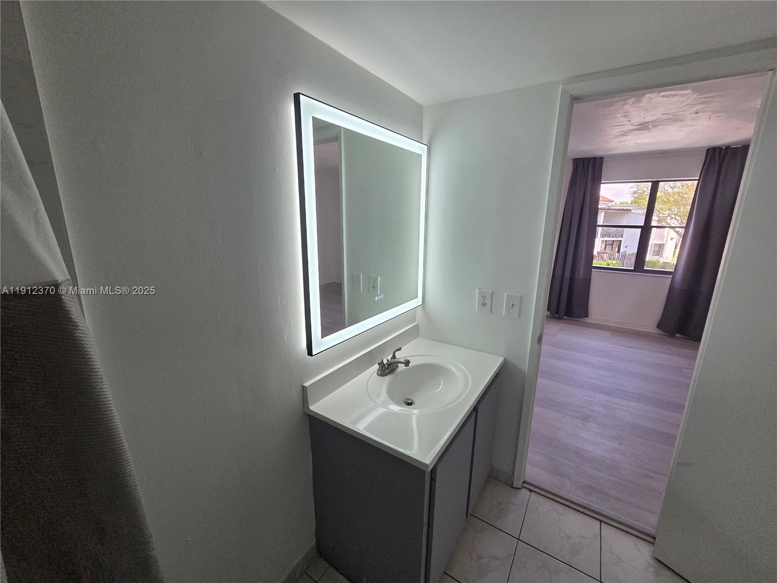 9433 Fontainebleau Boulevard, Unit 212 Miami, FL 33172 - Photo 21 of 45 a bathroom with a sink and a mirror