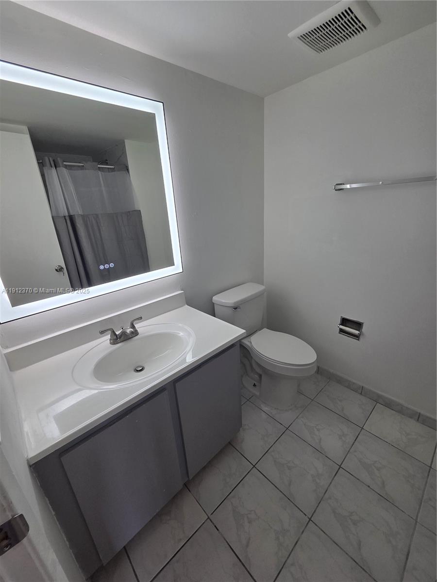 9433 Fontainebleau Boulevard, Unit 212 Miami, FL 33172 - Photo 26 of 45 a bathroom with a sink and a mirror