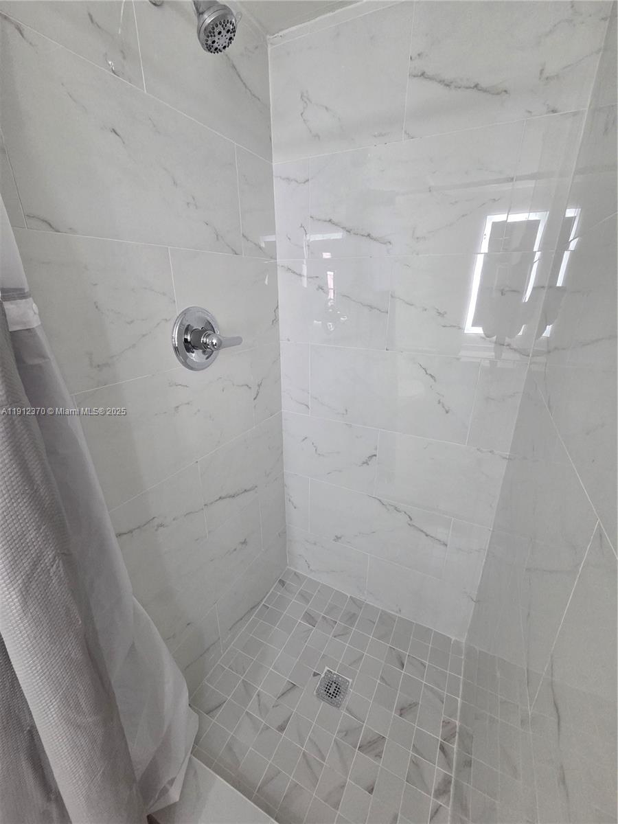 9433 Fontainebleau Boulevard, Unit 212 Miami, FL 33172 - Photo 28 of 45 a bathroom with a shower