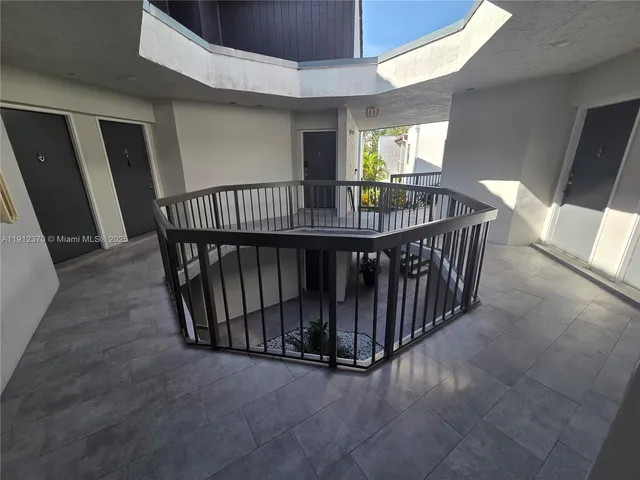 a view of a hallway with paintings on the wall