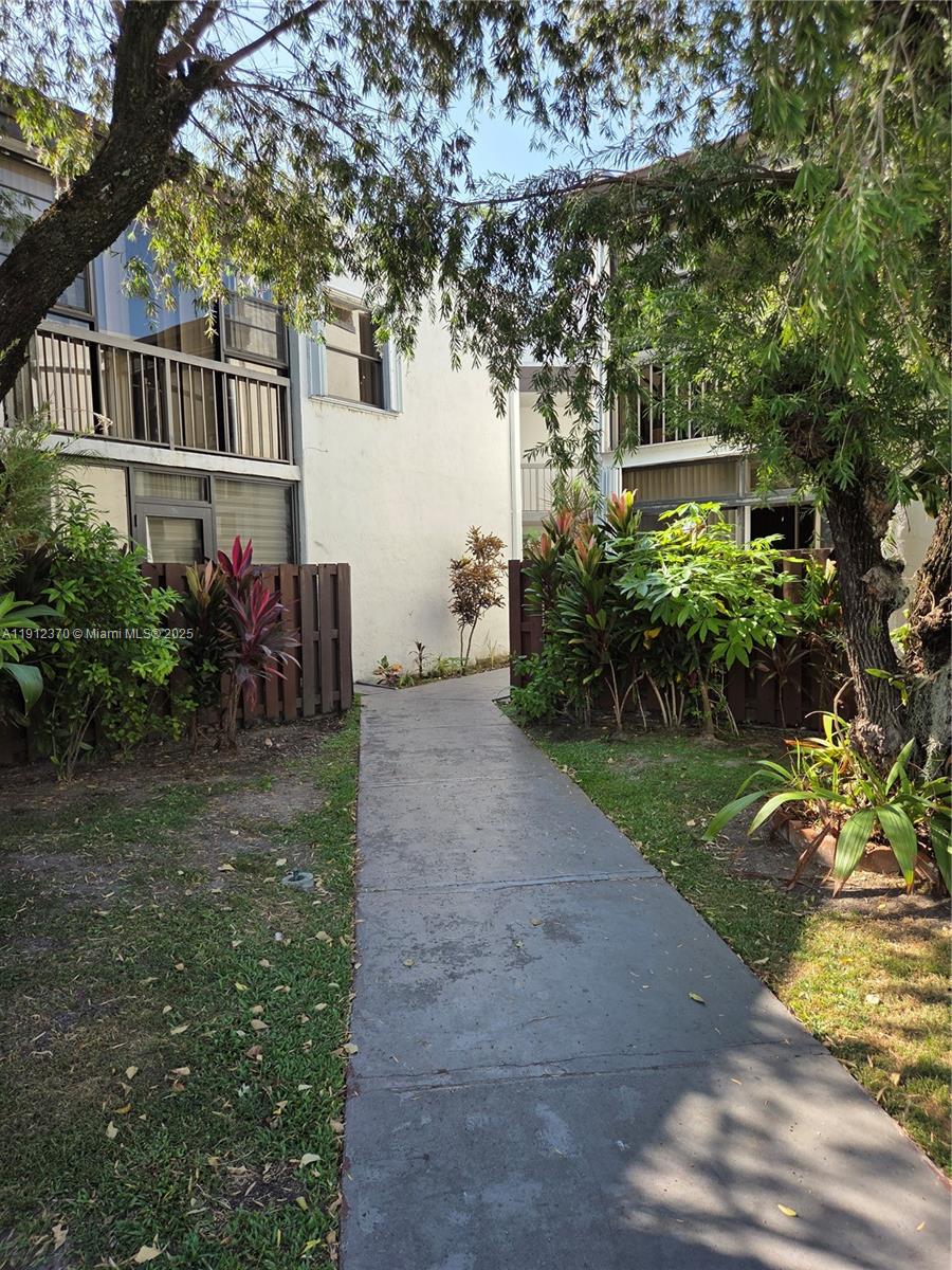 9433 Fontainebleau Boulevard, Unit 212 Miami, FL 33172 - Photo 43 of 45 front view of house with a yard