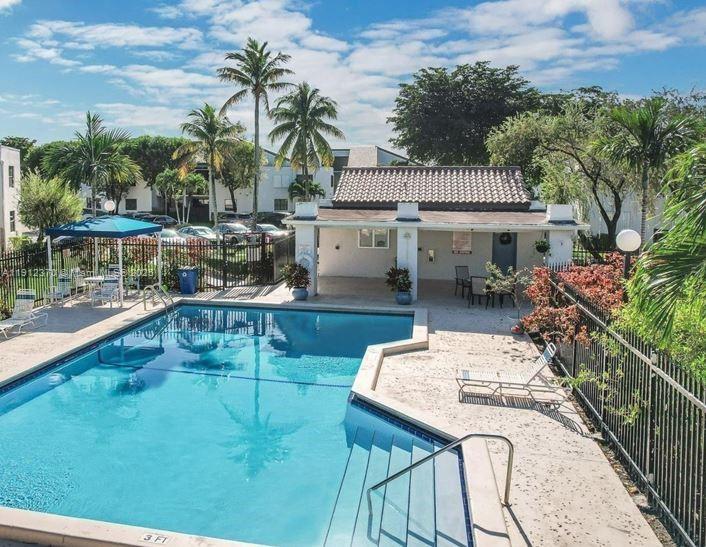 9433 Fontainebleau Boulevard, Unit 212 Miami, FL 33172 - Photo 44 of 45 a balcony with table and chairs