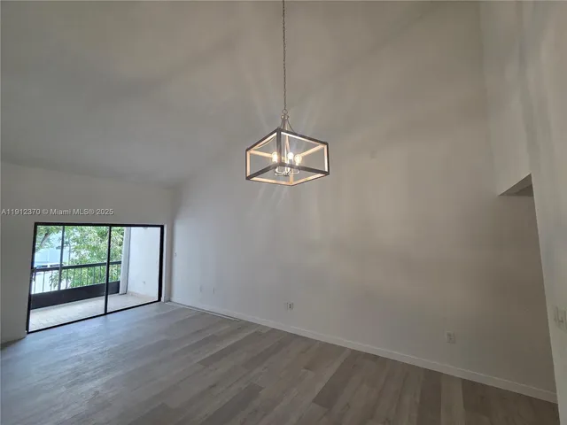 a view of a room with wooden floor and window