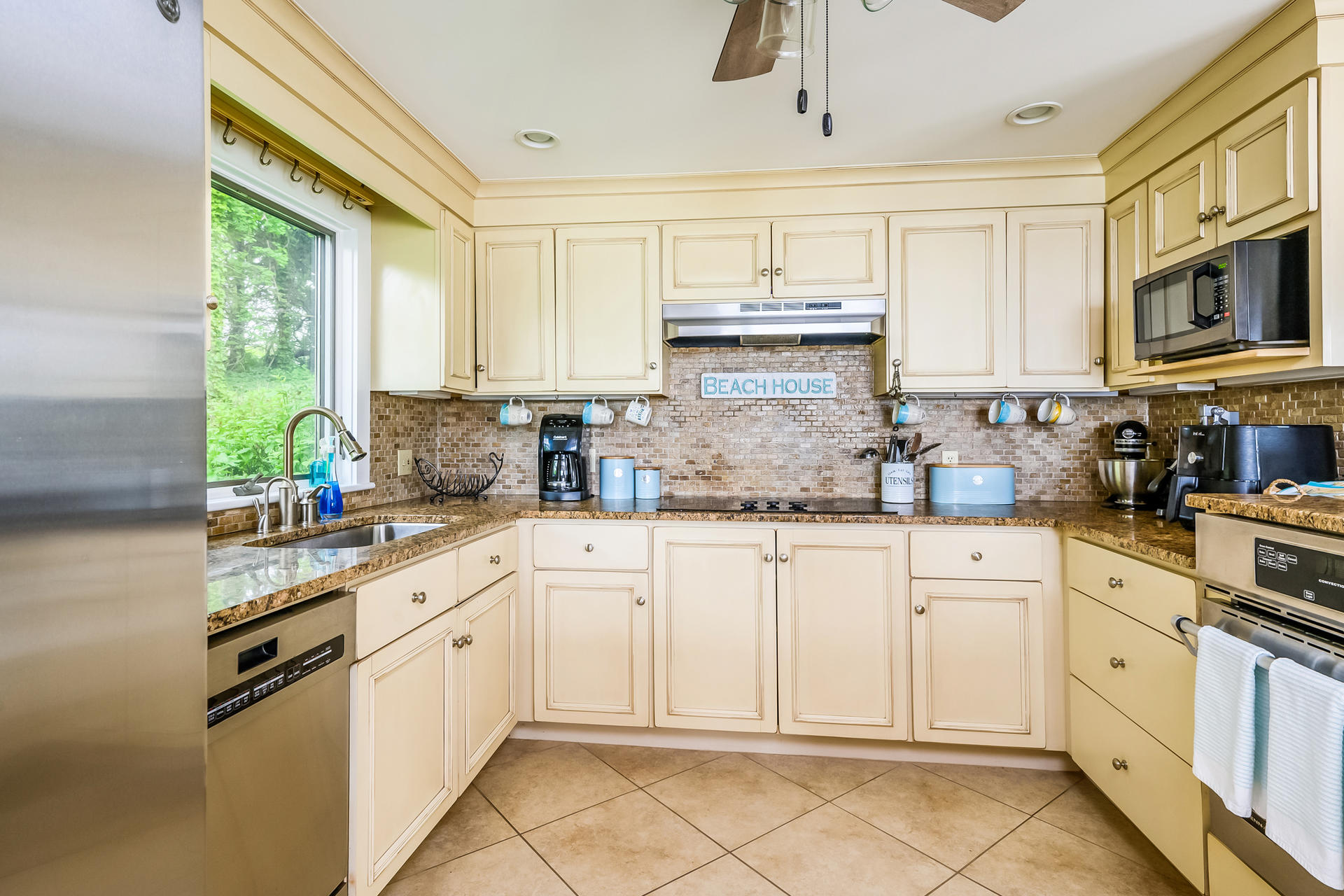 33 Ruggles Road Orleans, MA 02653 - Photo 17 of 80 a kitchen with cabinets appliances a sink and a window