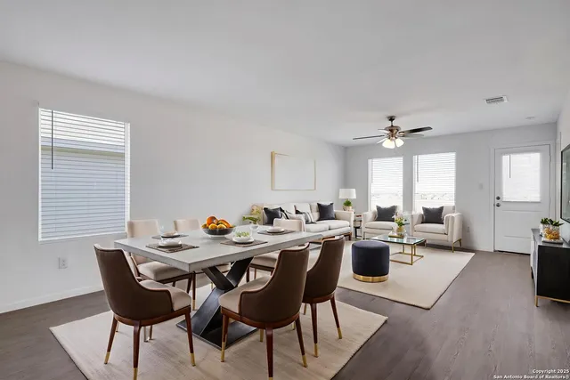 a view of a dining room with furniture and wooden floor