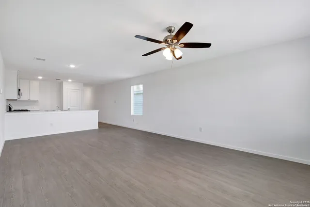 a view of a livingroom with a ceiling fan and window