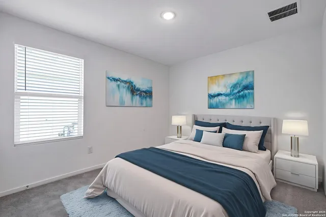 a bedroom with a bed and a painting on the wall