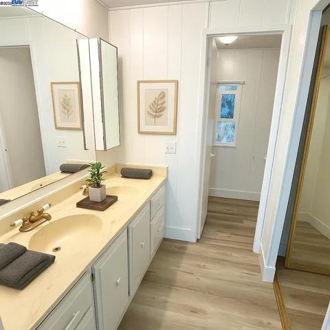 a bathroom with a double vanity sink and a mirror