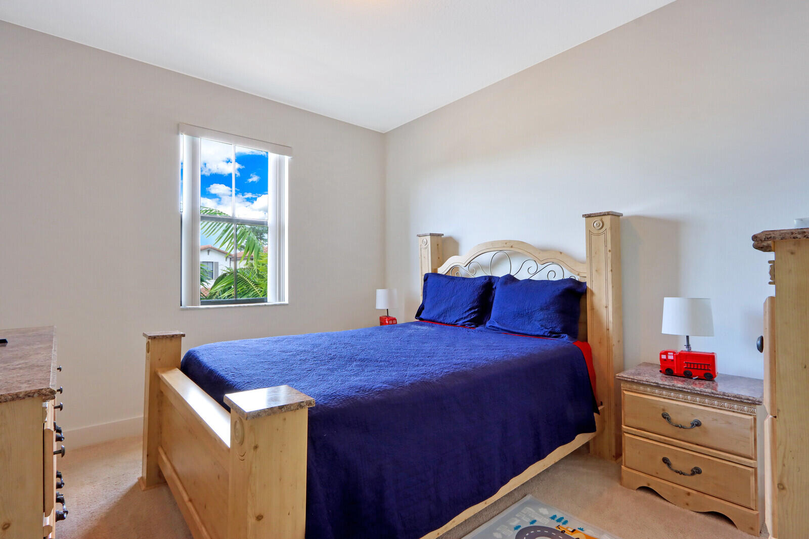 6024 Pine Tree Way Riviera Beach, FL 33410 - Photo 15 of 26 a bedroom with a bed and a window